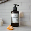 8 oz Hand + Body moisturizer in amber bottle scented Grapefruit Mango
